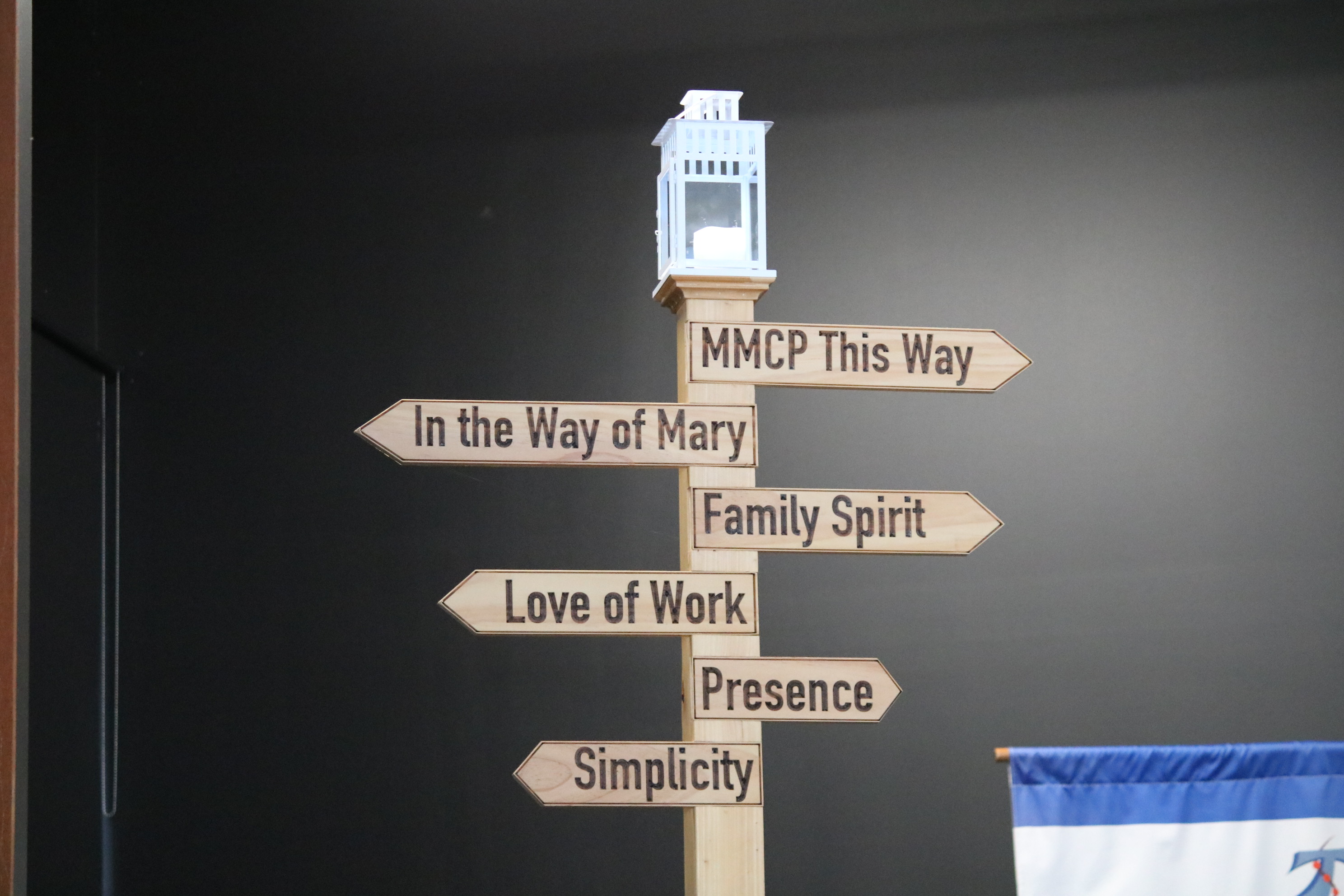 Sign post with lantern of the Marist Characteristics
