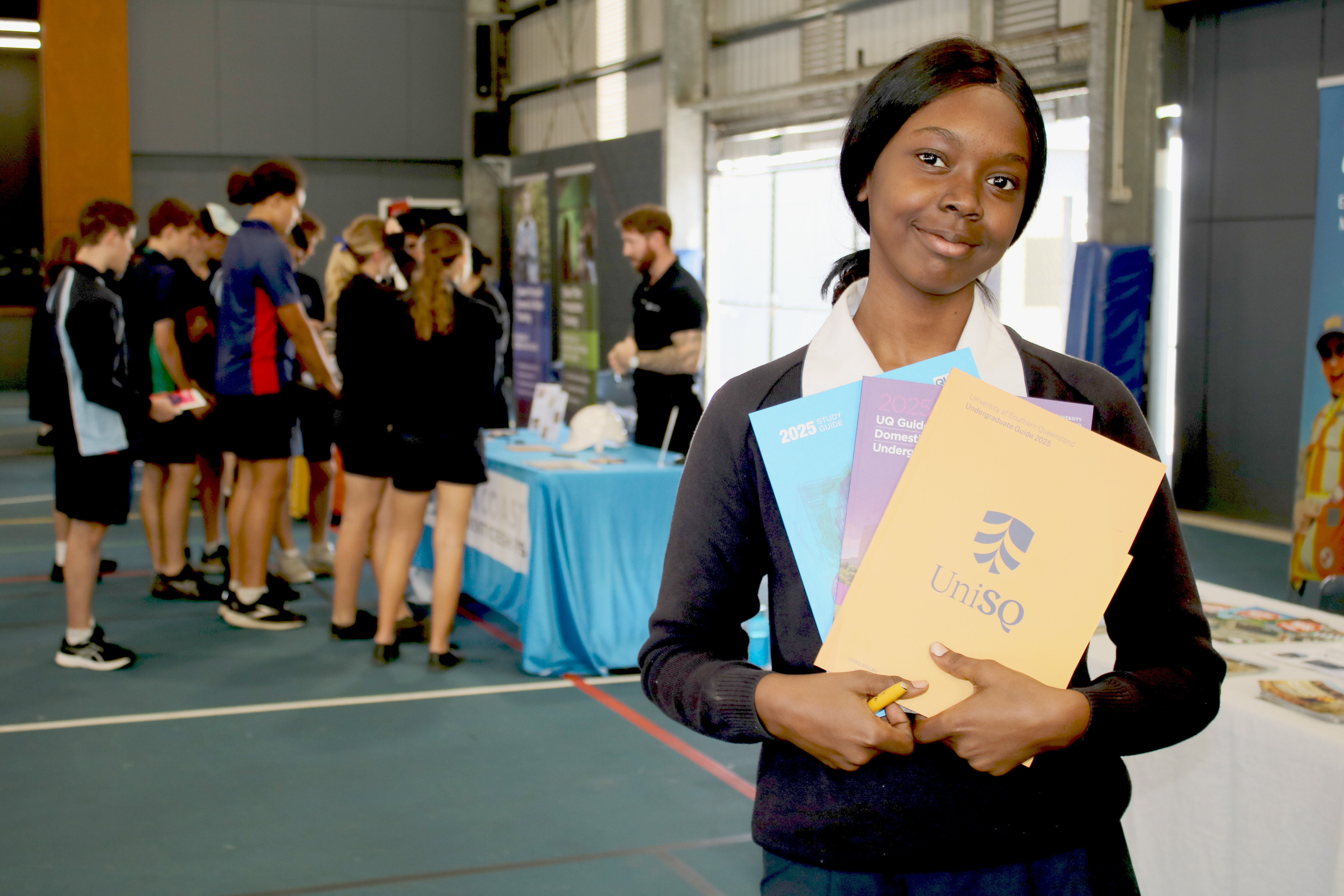 Student holding a UniSQ Prospectus 